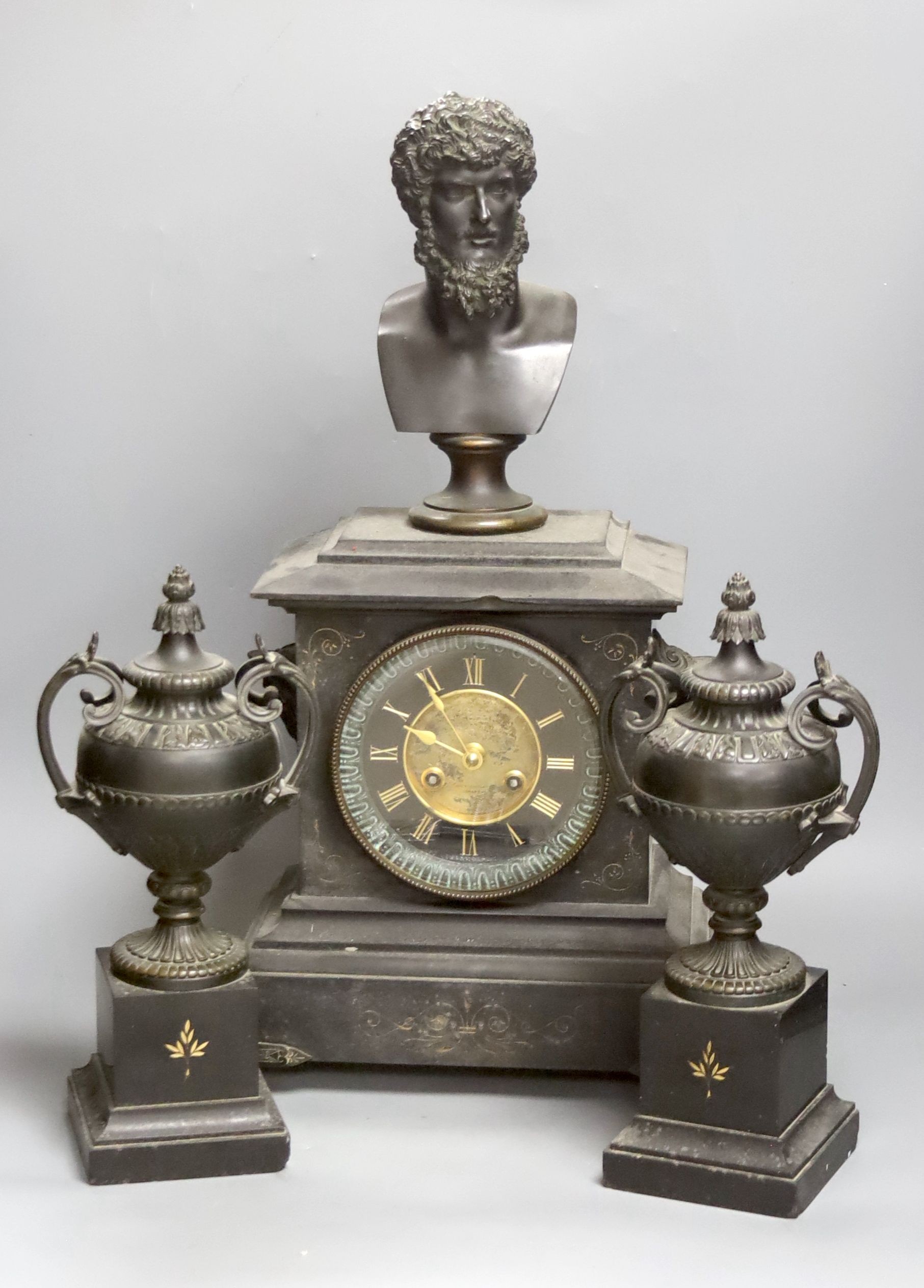 A Victorian black marble and bronze three piece clock garniture. Key and pendulum. 54cm